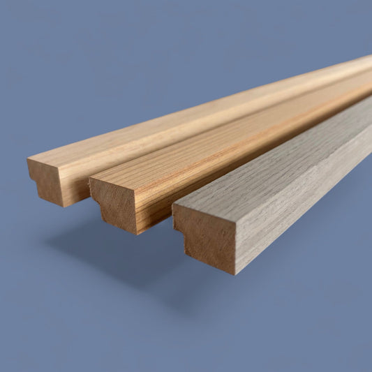 Three wooden planks (Vantaa Lamelles) with different finishes on a blue background