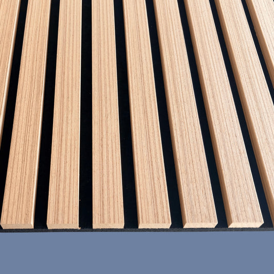 Edge detail of Vantaa Brown wood slat acoustic panel, highlighting thickness, precise cuts, and natural finish on blue base.