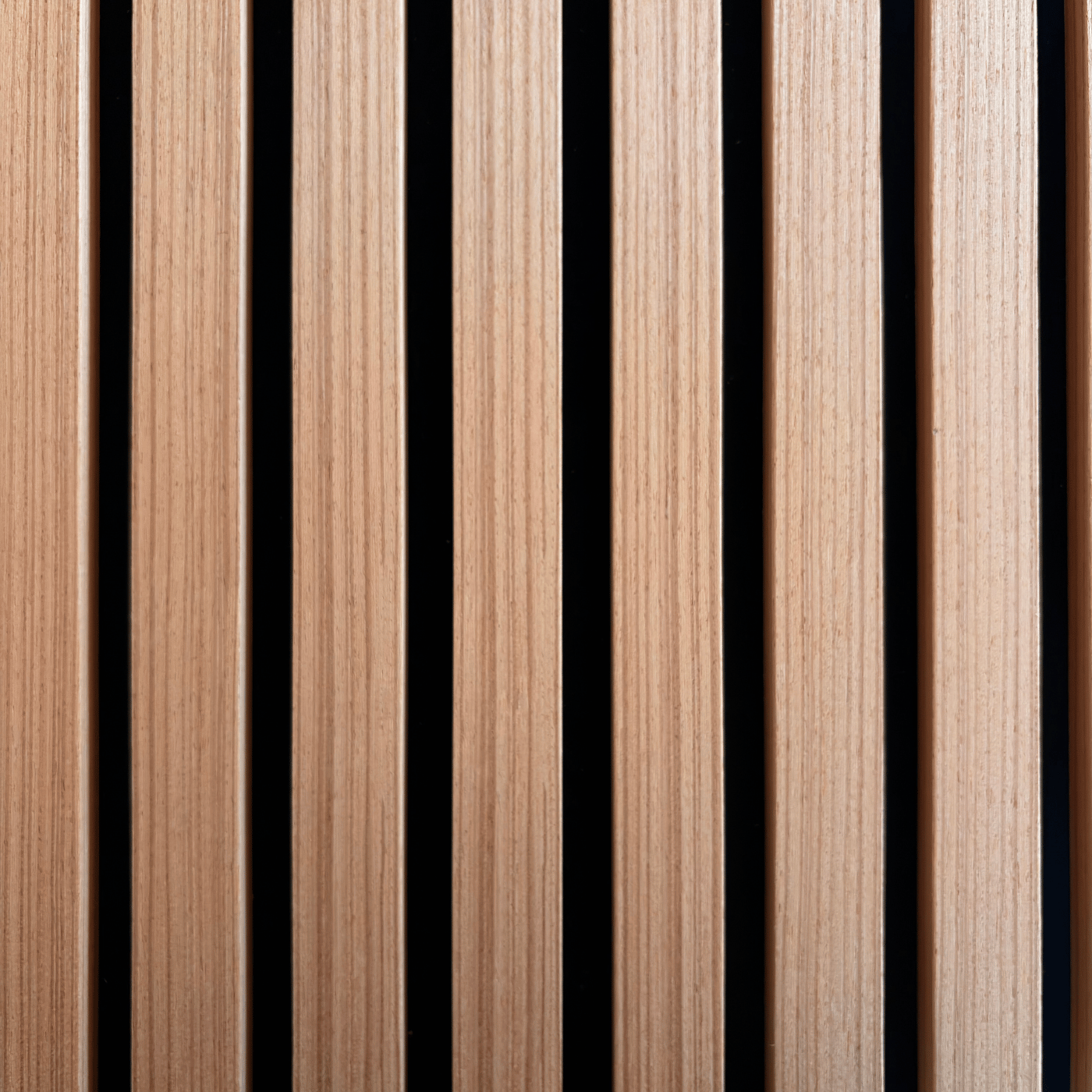 Angled close-up of Vantaa Brown wood slat panel floating above teal surface, emphasizing slatted design and warm brown tones.
