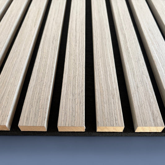 Detailed close-up of Vantaa Grey acoustic wood slats on blue background, highlighting texture, spacing, and premium sound-absorbing quality.